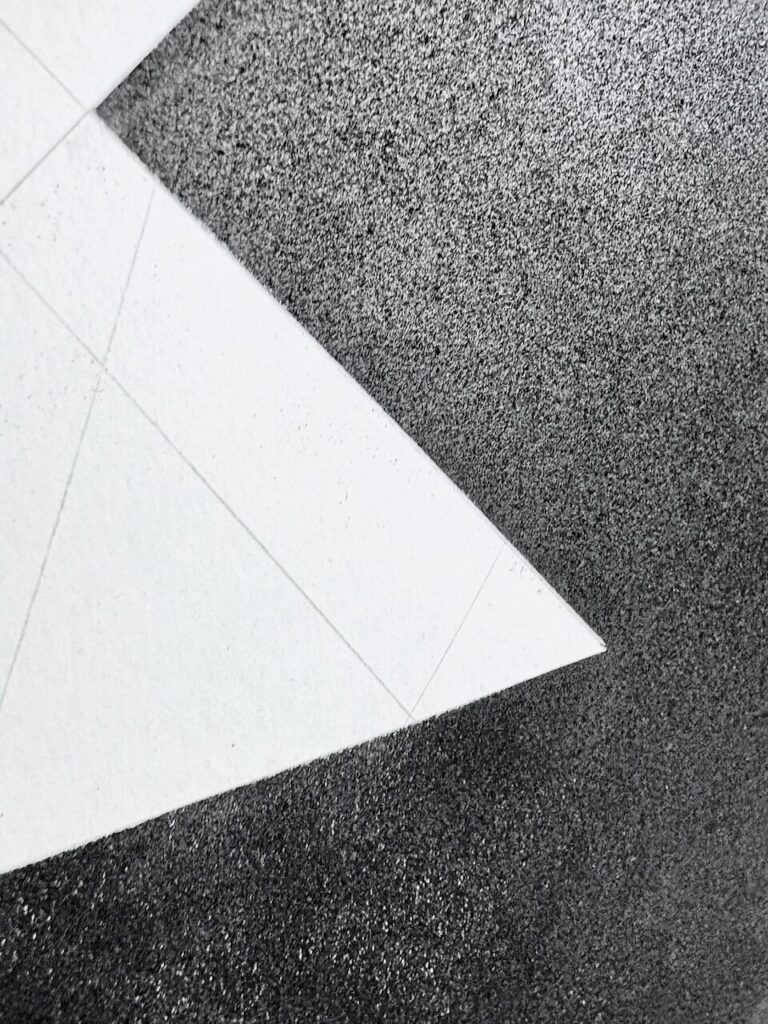 Extreme close-up of Unnamed Glyph (Glyph Drawing No. 14) surface, highlighting fine texture of paper, subtle variations in charcoal-dusted oil stick, white cut-ins of unmarked paper, and faint graphite grid lines beneath.